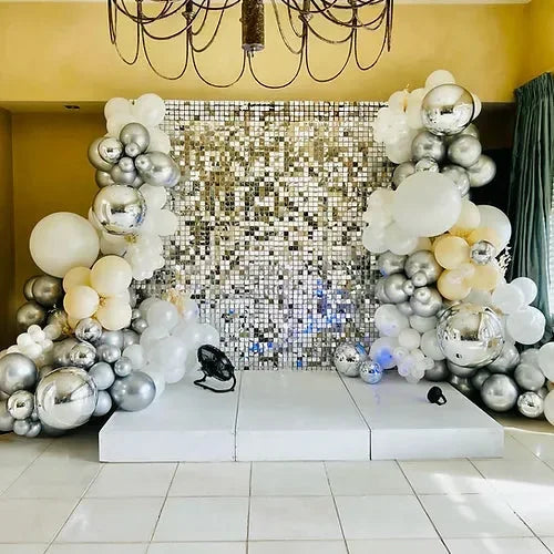 Silver Shimmer wall and a stage rental - Balloonz