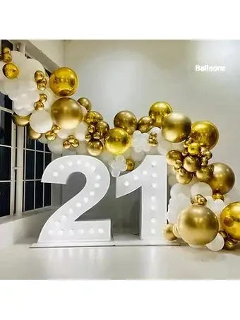 Big 21 number with lights and balloons in gold and white 