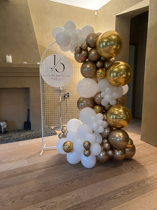 White and gold balloon garland on stand