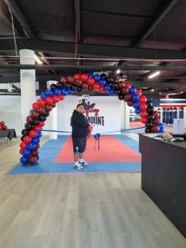 Self standing indoor balloon arch red, blue, maroon and black